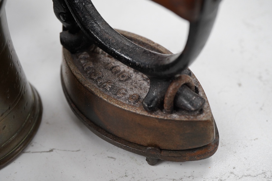 Sundry items to include a large pestle, spice grinder, flat iron on stand, bronze mortar and three other items, largest 42cm in length